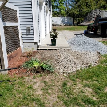 Rock Solid Landscaping Incorporated - The before of a wall and mulch bed. - Landscaping Near Me - Fall River, Massachusetts Rock Solid Landscaping Incorporated - The before of a wall and mulch bed. - Landscaping Near Me - Fall River, Massachusetts