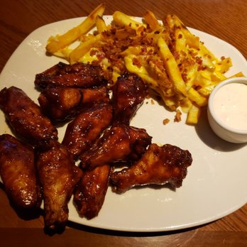 Outback Steakhouse - BBQ chicken wings along with cheesy fries - Steakhouses Near Me - Indianapolis, Indiana