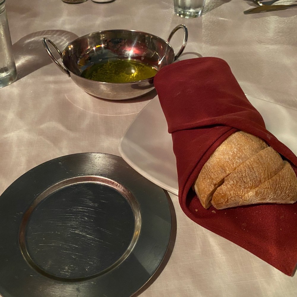 Cafe Della Via - Homemade loaf of bread and garlic olive oil - Italian Near Me - Cayucos, California Cafe Della Via - Homemade loaf of bread and garlic olive oil - Italian Near Me - Cayucos, California