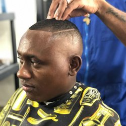 Dayton Grooming - Bald fade with hard part.