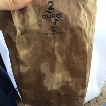 Devil's Teeth Baking Company - The smallest bag they had to fit four beignets and absolutely no space to shake the powdered sugar around...where are your brains people? - Bakeries Near Me - San Francisco, California