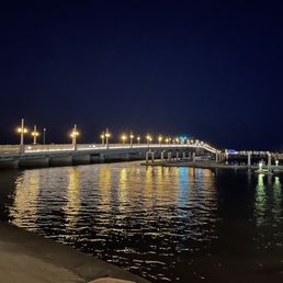Beautiful nighttime shot of the night lights reflecting on the river below. Beautiful nighttime shot of the night lights reflecting on the river below.