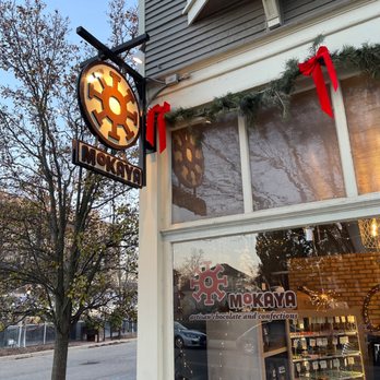 Mokaya - the outside of a restaurant with a clock - Chocolatiers & Shops Near Me - Grand Rapids, Michigan