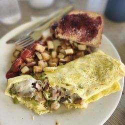 Water's Edge Cafe - Build Your Own Omelet stuffed with pepperjack cheese, ham, mushrooms, onions, and peppers. Comes with choice of side and bread.