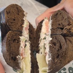 Vegan Pumpernickle Rye Bagel  with scallion tofu spread, capers, tomato, and cucumber