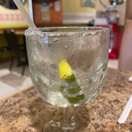 a glass of water with a lime slice in it a glass of water with a lime slice in it