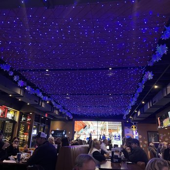 Bix - people sitting at tables in a restaurant under blue lights - Sports Bars Near Me - West Des Moines, Iowa Bix - people sitting at tables in a restaurant under blue lights - Sports Bars Near Me - West Des Moines, Iowa