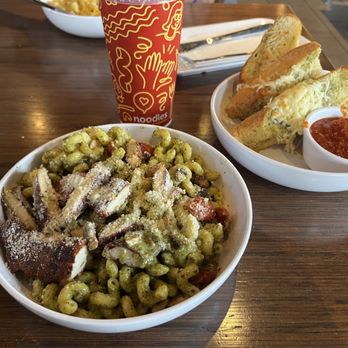 Noodles and Company - Pesto with Parmesan crusted chicken and garlic bread - Noodles Near Me - Cincinnati, Ohio Noodles and Company - Pesto with Parmesan crusted chicken and garlic bread - Noodles Near Me - Cincinnati, Ohio