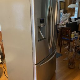 My old refrigerator that works but has been moved three times now .