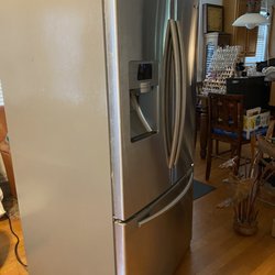 My old refrigerator that works but has been moved three times now .