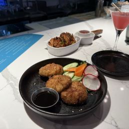 Chive dumplings and mini veggie pancakes. Also, the lychee cosmo. Chive dumplings and mini veggie pancakes. Also, the lychee cosmo.