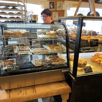 B. Food - a woman behind a bakery counter - Bakeries Near Me - Milford, Massachusetts B. Food - a woman behind a bakery counter - Bakeries Near Me - Milford, Massachusetts