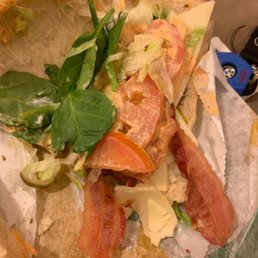 a sandwich with bacon, lettuce, and cheese