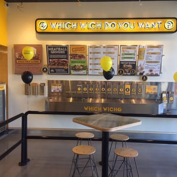 Which Wich - a table with stools and a sign that says which wich do you want? - Sandwiches Near Me - Westwood, Massachusetts Which Wich - a table with stools and a sign that says which wich do you want? - Sandwiches Near Me - Westwood, Massachusetts