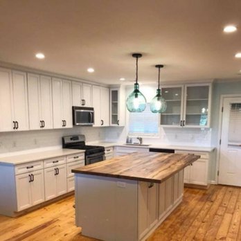 Dale Brother's Construction - a kitchen with white cabinets and wood floors - General Contractors Near Me Dale Brother's Construction - a kitchen with white cabinets and wood floors - General Contractors Near Me