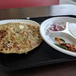 Aloo paratha with butter, pickles, curd and onion. Aloo paratha with butter, pickles, curd and onion.