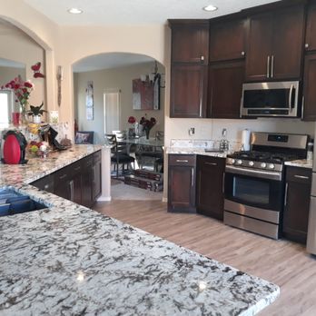 Tile Mart - a kitchen with granite countertops and stainless steel appliances - Flooring Near Me - Albuquerque, New Mexico Tile Mart - a kitchen with granite countertops and stainless steel appliances - Flooring Near Me - Albuquerque, New Mexico