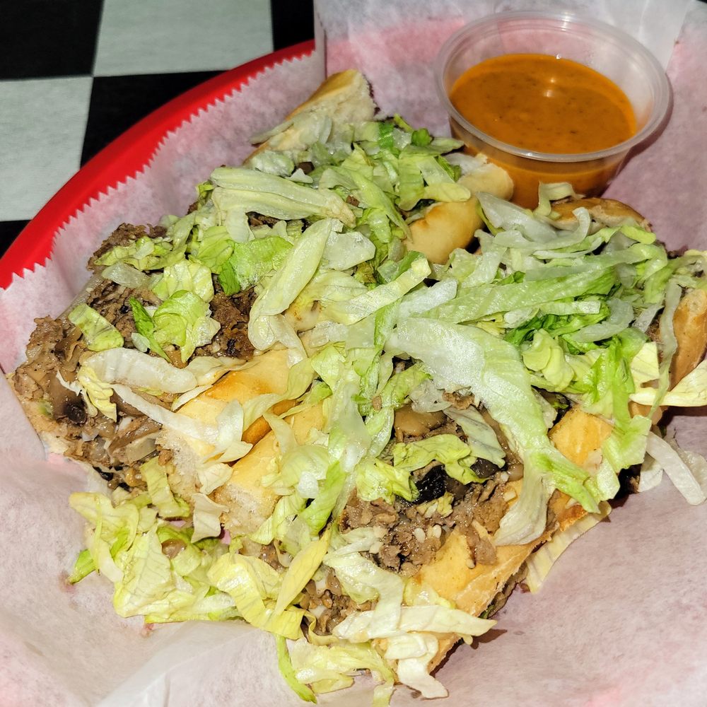 Z-28 Cheesesteak w/ side of Turbo Sauce.  Lots of steak & cheese under that lettuce!