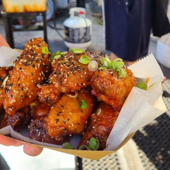 Pin Pan Pollo - a person holding a basket of food - Chicken Wings Near Me Pin Pan Pollo - a person holding a basket of food - Chicken Wings Near Me