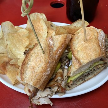 Eli's Essentials and Wine Bar - Porchetta on mini Baguette (plate was tiny which made the sandwich look huge) $16 - Cafes Near Me - New York, New York