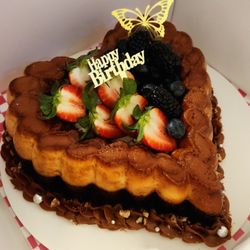 Cynthia's Crumbly Creations - Chocoflan Cake, is a chocolate cake on bottom and delicious homemade Flan on top, decorated with Dulce de Leche and fresh berries