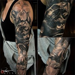 Ulibarri Ink & Art Gallery - Skull and flower sleeve tattoo by Brian Ulibarri