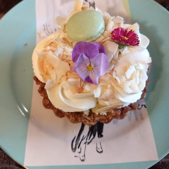 Noisette Pastry Kitchen - Coconut cream tart with pretty seasonal flowers and a bonus mini macron. - Bakeries Near Me - Eugene, Oregon Noisette Pastry Kitchen - Coconut cream tart with pretty seasonal flowers and a bonus mini macron. - Bakeries Near Me - Eugene, Oregon