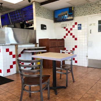 Hook Fish & Chicken - a table and chairs in a restaurant - Chicken Wings Near Me - West Palm Beach, Florida