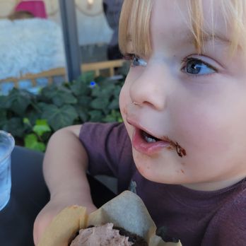 Natural Sprinkles - a child eating a chocolate cupcake - Bakeries Near Me - Albany, Oregon Natural Sprinkles - a child eating a chocolate cupcake - Bakeries Near Me - Albany, Oregon