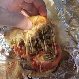 Beautiful greasy perfect cheeseburger mozzarella grilled tomato and jalapeño on a Kaiser roll what more could you ask for!