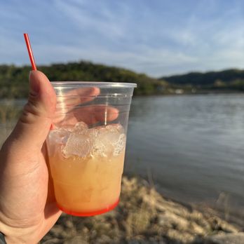 Drew’s On The River - a hand holding a drink - Dive Bars Near Me - Cincinnati, Ohio