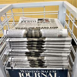 Winston-Salem Journal - Stack of Winston-Salem Journal papers.