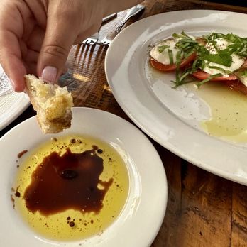 Osteria Grappolo - Caprese Salad and fresh baked sourdough bread. - Italian Near Me - Solvang, California Osteria Grappolo - Caprese Salad and fresh baked sourdough bread. - Italian Near Me - Solvang, California