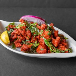Verandah Indian Cuisine - Crispy cauliflower florets tossed in bold Indian spices, deep-fried to perfection for a flavorful and crunchy appetizer.