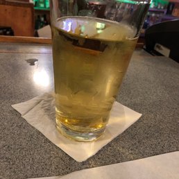 a glass of beer on a table a glass of beer on a table