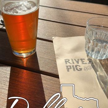 River Pig Saloon - a glass of beer on a table - Sports Bars Near Me - Dallas, Texas River Pig Saloon - a glass of beer on a table - Sports Bars Near Me - Dallas, Texas