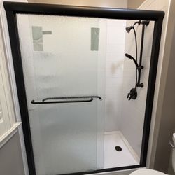 Bath Fitter - Shower remodel with sliding glass doors.