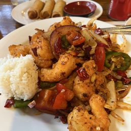 Spicy shrimp with steamed rice and spring rolls. Spicy shrimp with steamed rice and spring rolls.