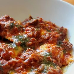 Stella 34 Trattoria - Ricotta Ravioli (Ricotta stuffed pasta, lamb ragout, pecorino, mint pesto).