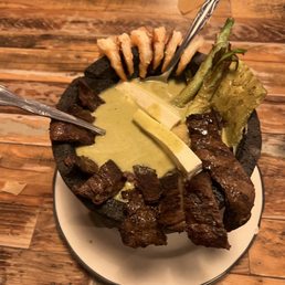 Molcajete (steak and shrimp) onions, cheese and cactus Molcajete (steak and shrimp) onions, cheese and cactus