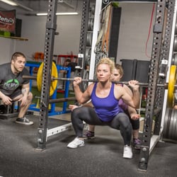 The Spot Athletics - Coaching clients to squat properly.
