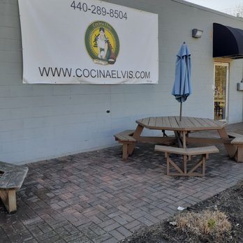 Cocina Elvis - a picnic table and umbrella in front of a building - Mexican Near Me - Painesville, Ohio