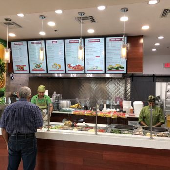 Healthy Delights - a man ordering food at a restaurant - Salad Near Me - Kendall, Florida