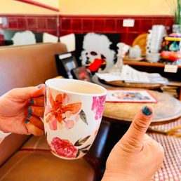 a hand holding a coffee cup