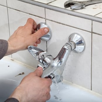 Donald R Kellett Plumbing & Heating - a man fixing a faucet - Plumbing Near Me - Troy, Michigan Donald R Kellett Plumbing & Heating - a man fixing a faucet - Plumbing Near Me - Troy, Michigan