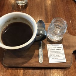 Coffee Guru - Tall black with description and sparking water
