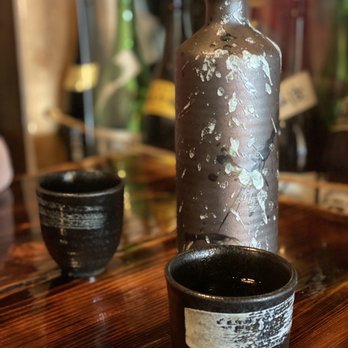Izakaya Tomo - a bottle and two bowls on a table - Japanese Near Me - Edmonton, Alberta Izakaya Tomo - a bottle and two bowls on a table - Japanese Near Me - Edmonton, Alberta