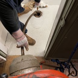 Drain line being snaked from basement bathroom. Drain line being snaked from basement bathroom.
