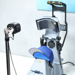 Heat transfer machine setup for DTF printing custom hats with a laser alignment tool