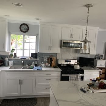 J & K Builders - a kitchen with white cabinets and stainless steel appliances - General Contractors Near Me - Chula Vista, California J & K Builders - a kitchen with white cabinets and stainless steel appliances - General Contractors Near Me - Chula Vista, California